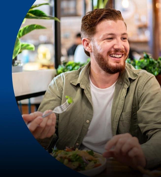 Smiling man eating a meal