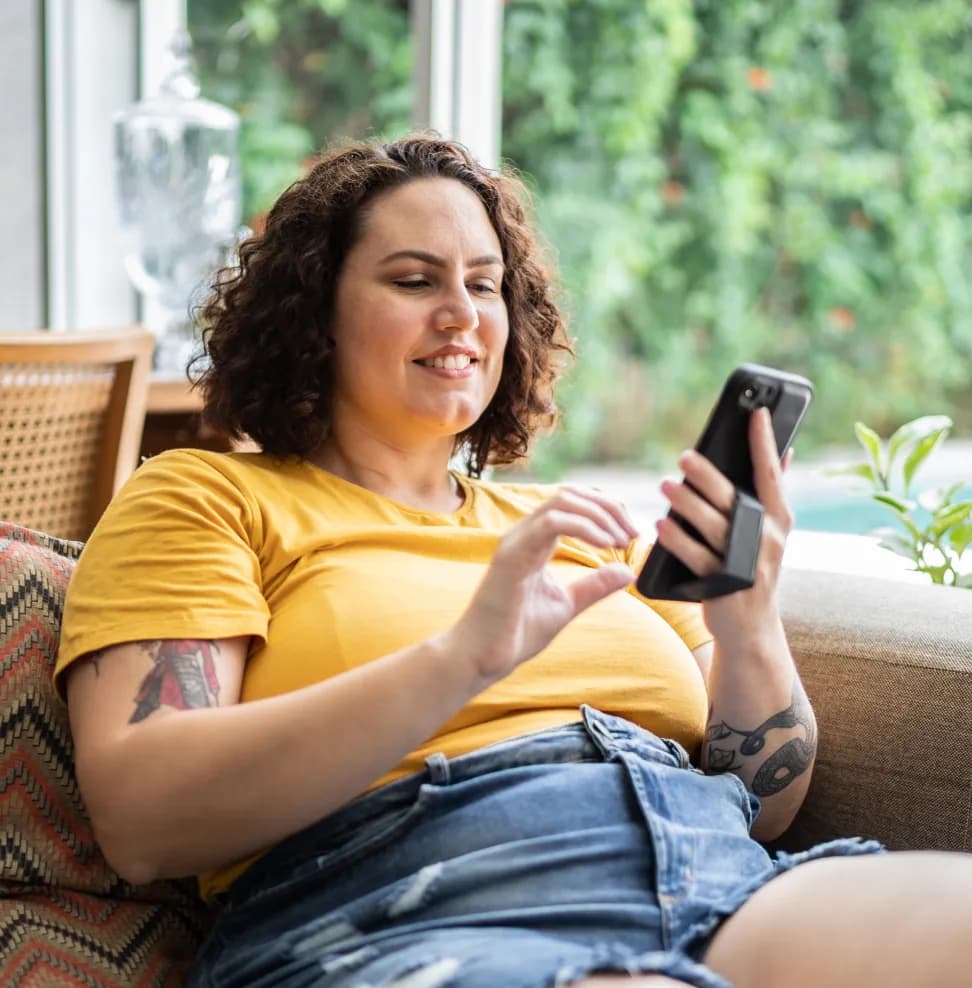 A smiling woman on her phone